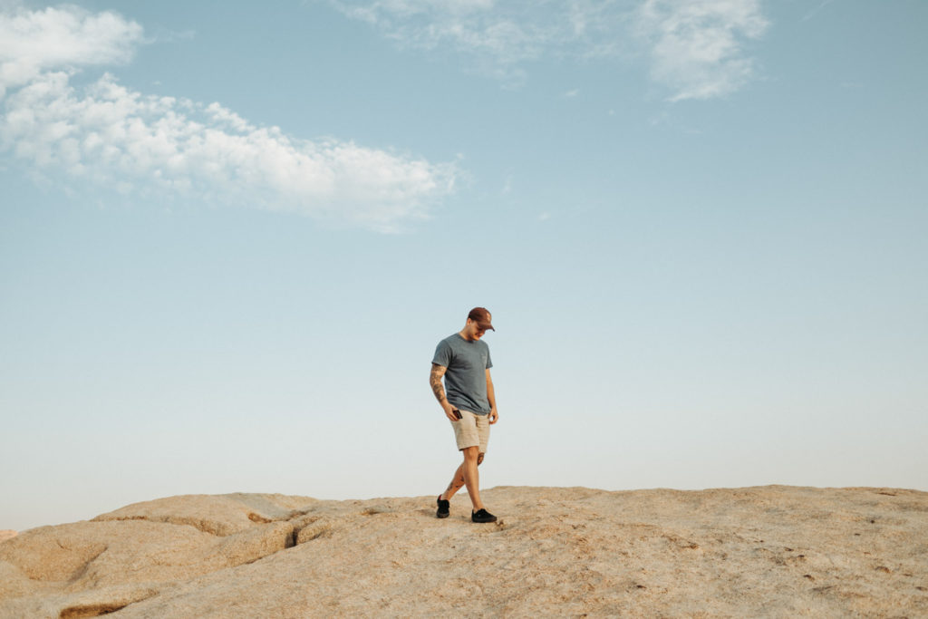 minimalist portrait of guy on boulder in joshua tree