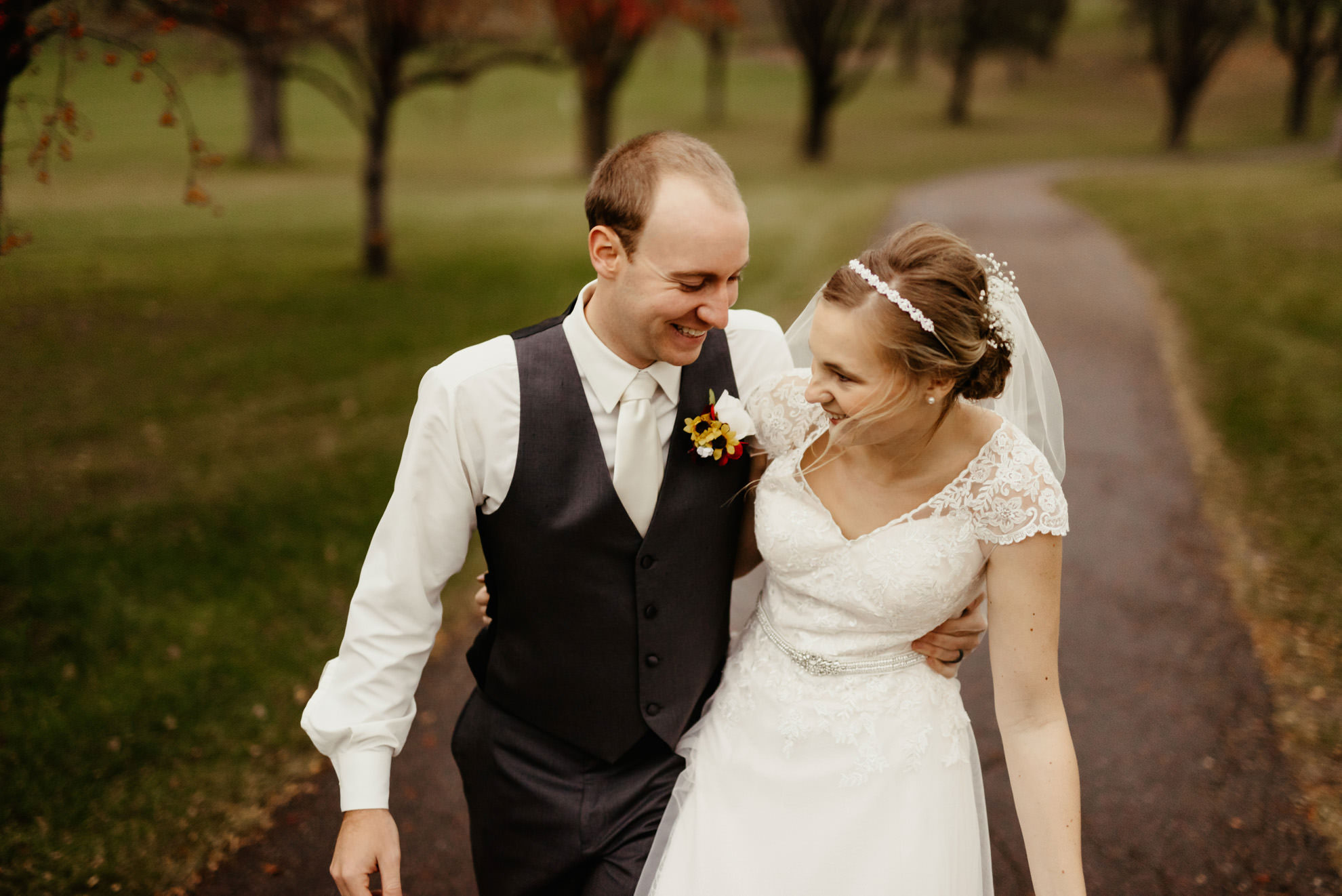 Bride and groom walking together laughing