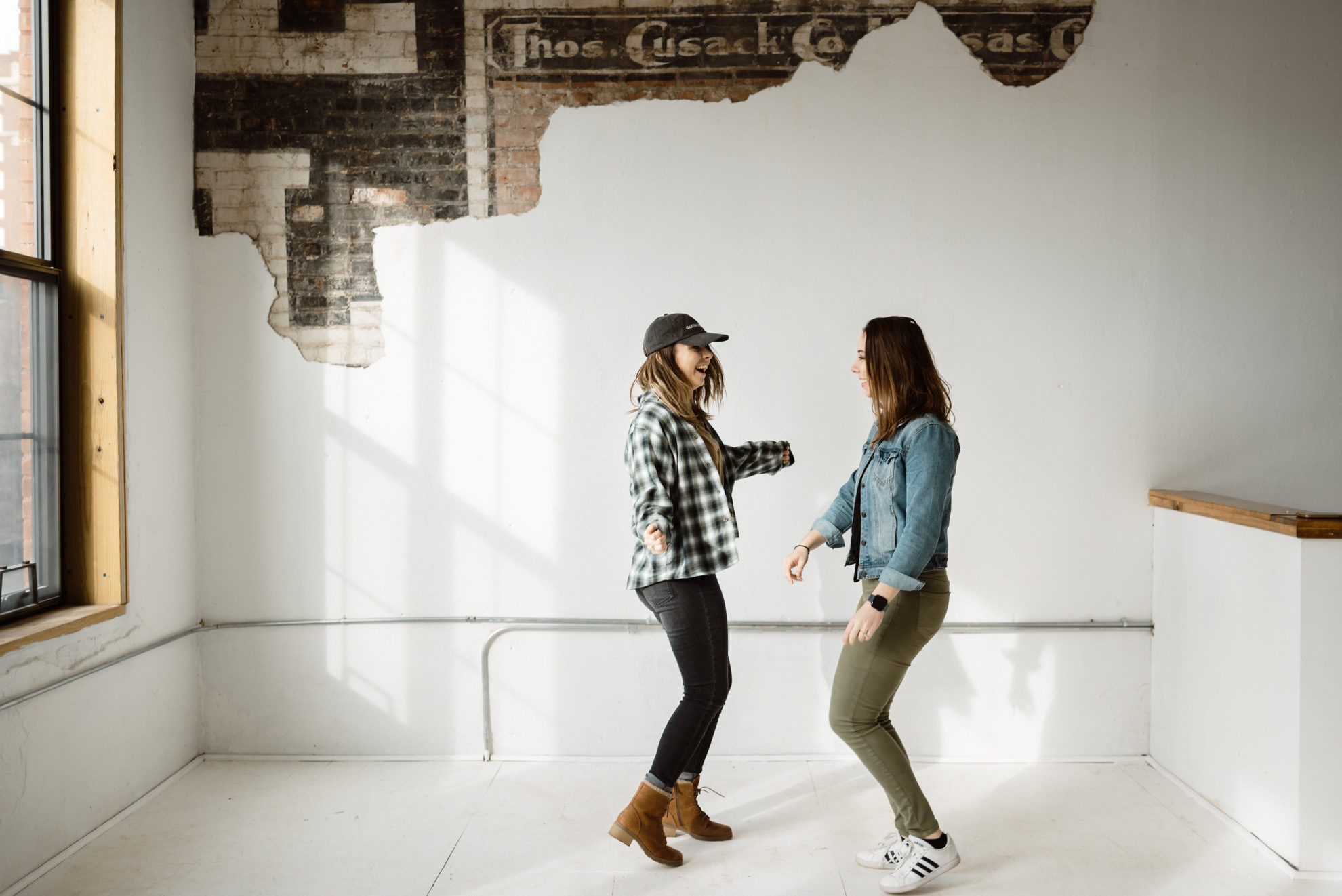 two girlfriends dancing in a photo studio