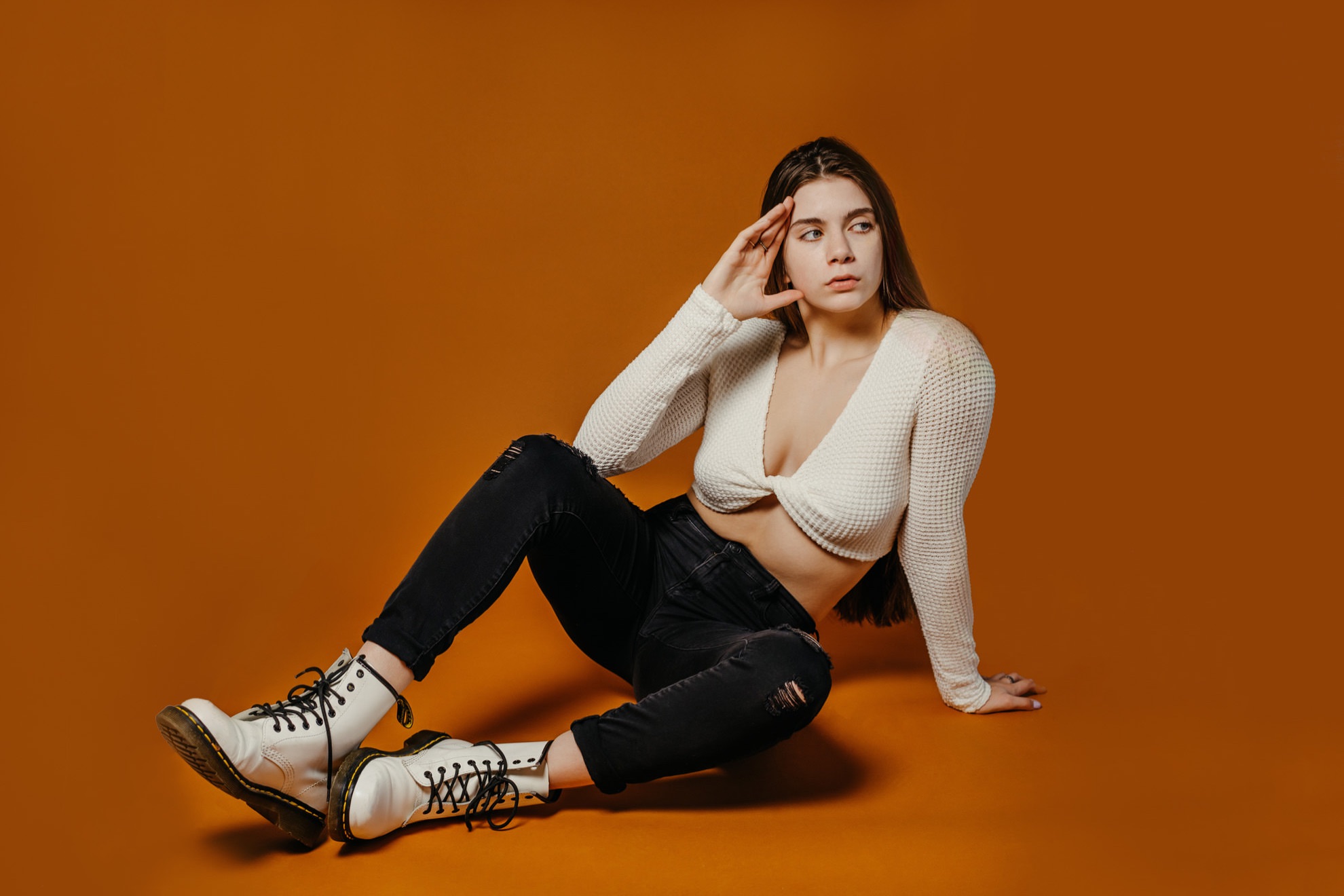 fashion photo of women in black and white outfit on orange background
