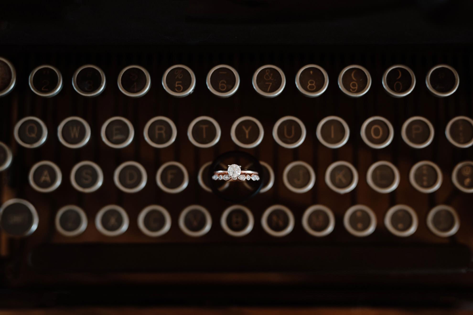 wedding rings placed on typewriter keys