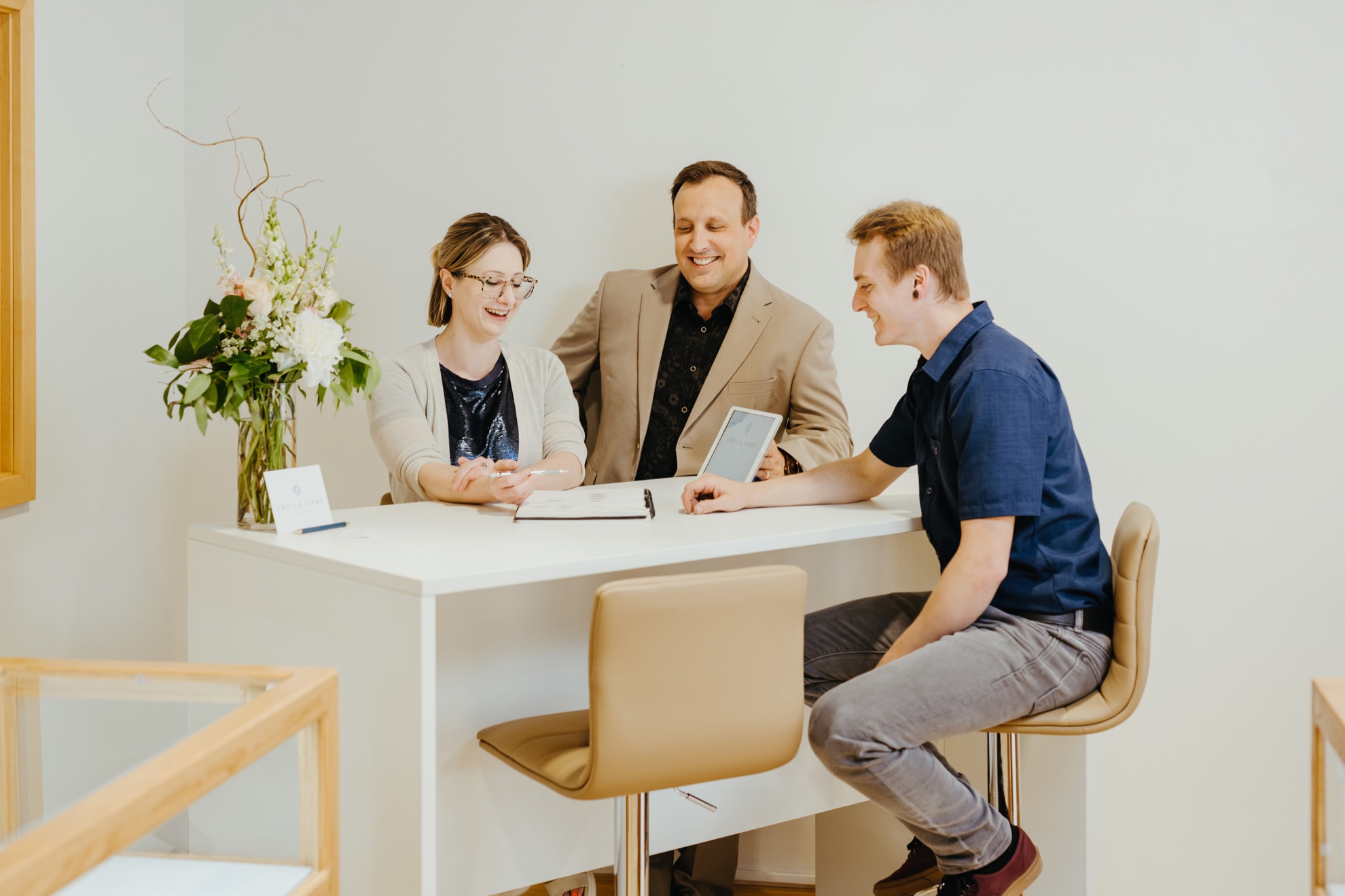 lifestyle photo of jewelry store team looking over designs together